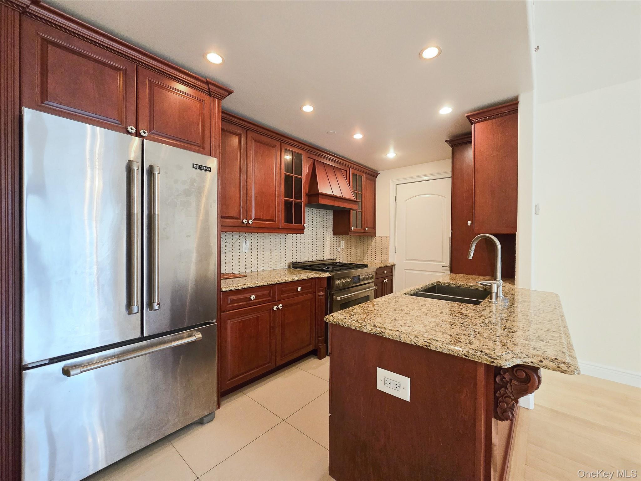 63-36 99th Street, Unit 5B Queens, NY 11374 - Photo 10 of 20 a kitchen with stainless steel appliances granite countertop a refrigerator a sink and a stove