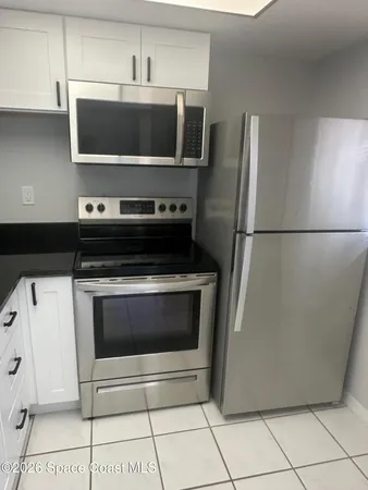 a stove top oven sitting inside of a kitchen