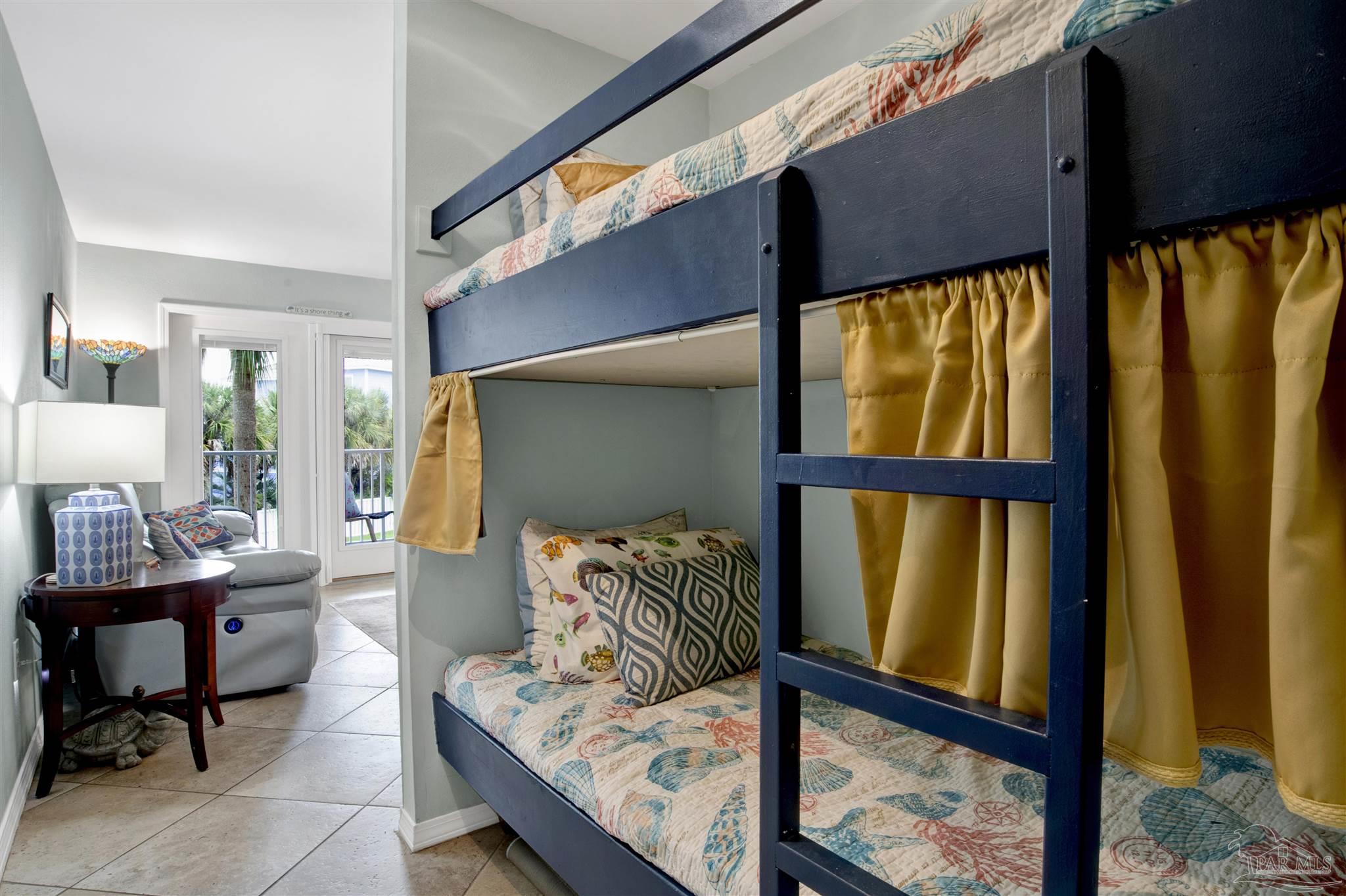 13351 Johnson Beach Road, Unit 203E Perdido Key, FL 32507 - Photo 26 of 55 a bedroom with furniture and a window