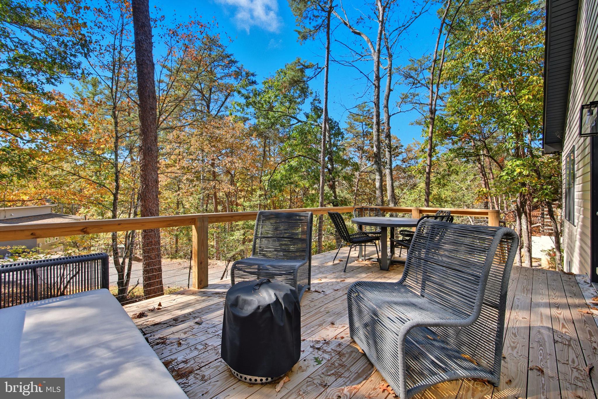 395 Deloris Road Mount Jackson, VA 22842 - Photo 11 of 48 a view of a balcony with chairs and wooden fence