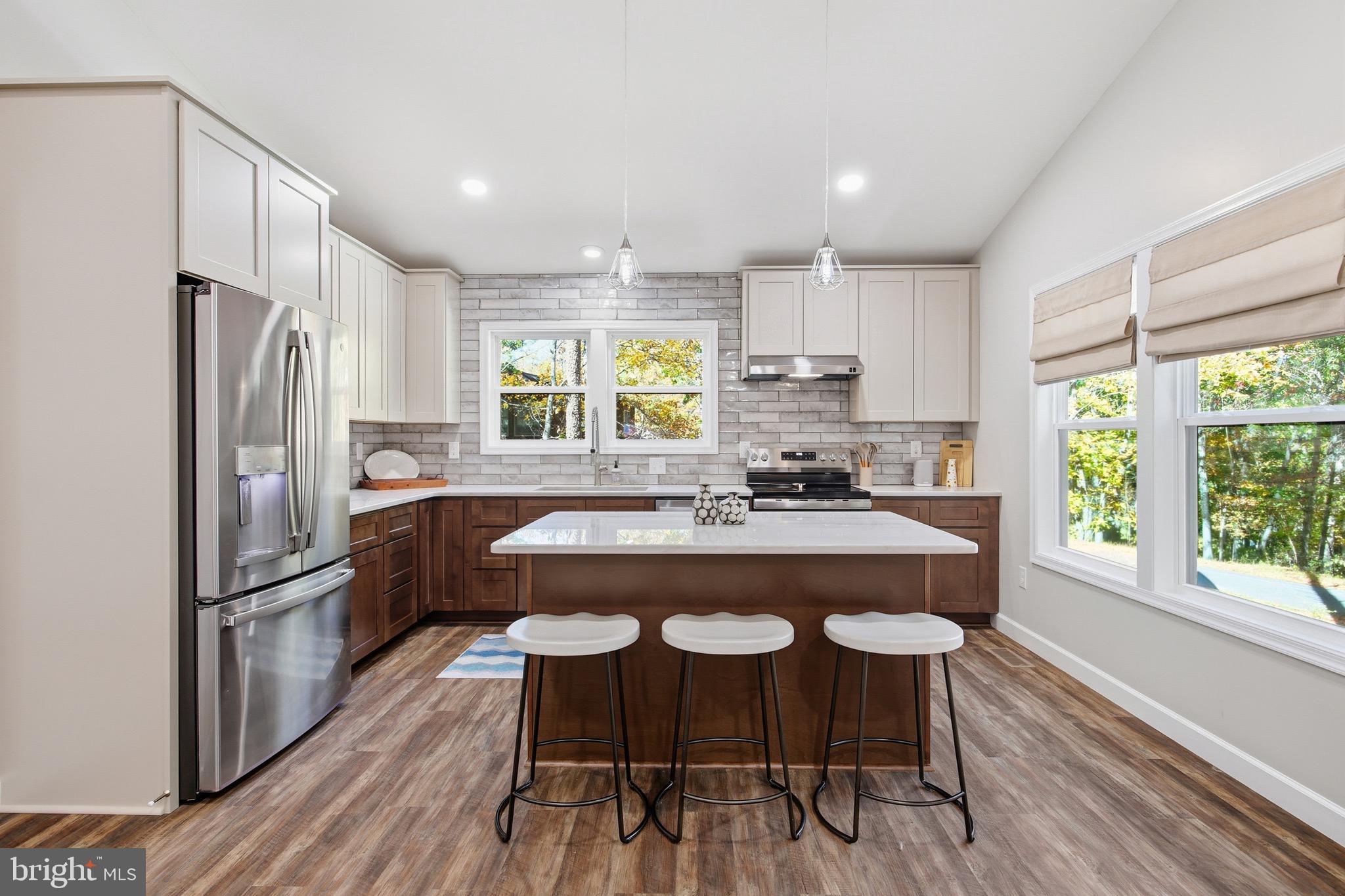 395 Deloris Road Mount Jackson, VA 22842 - Photo 12 of 48 a kitchen with stainless steel appliances granite countertop a refrigerator a sink dishwasher a stove and white countertops with wooden floor