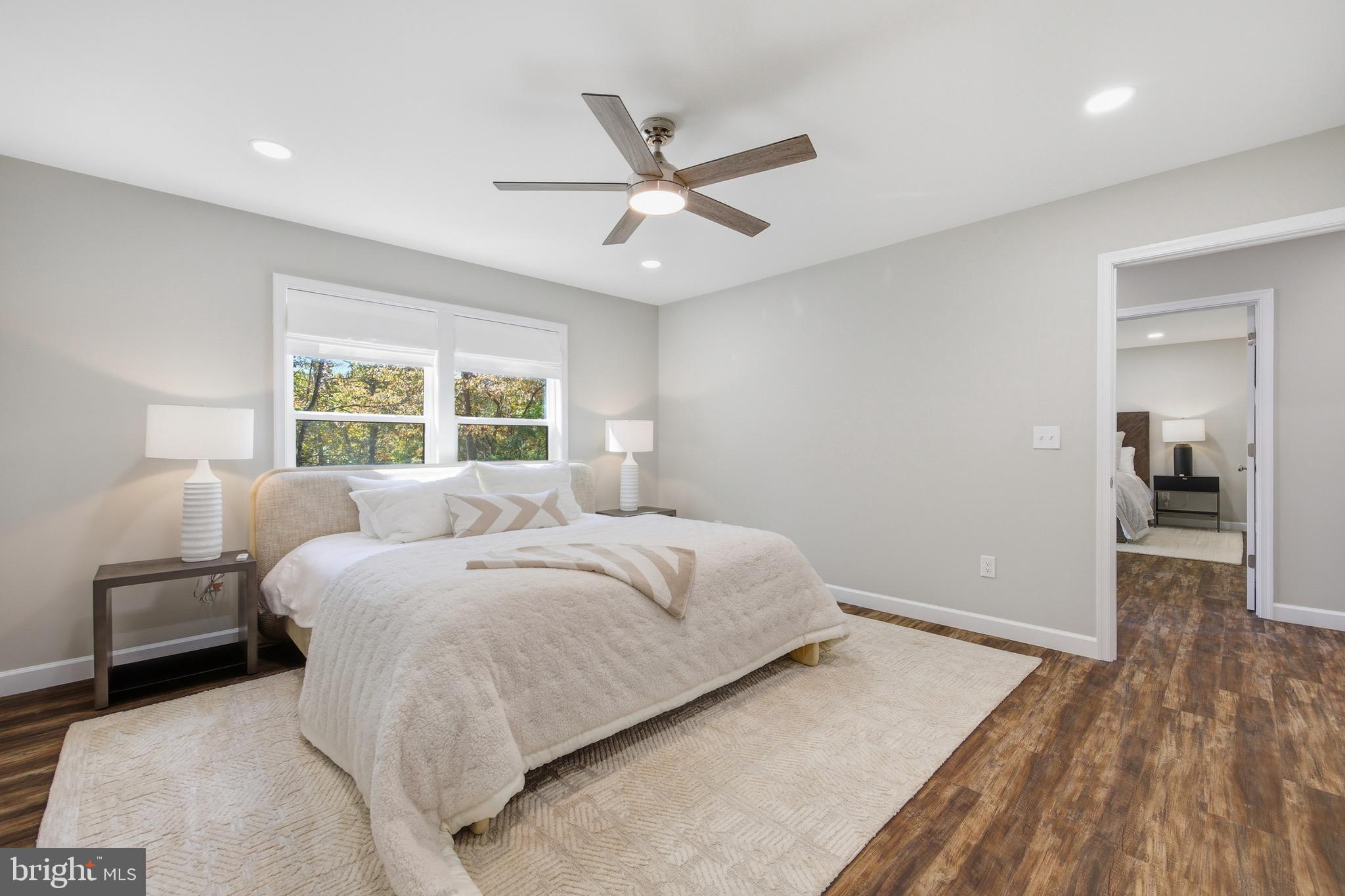 395 Deloris Road Mount Jackson, VA 22842 - Photo 23 of 48 a bedroom with a large bed and a chandelier