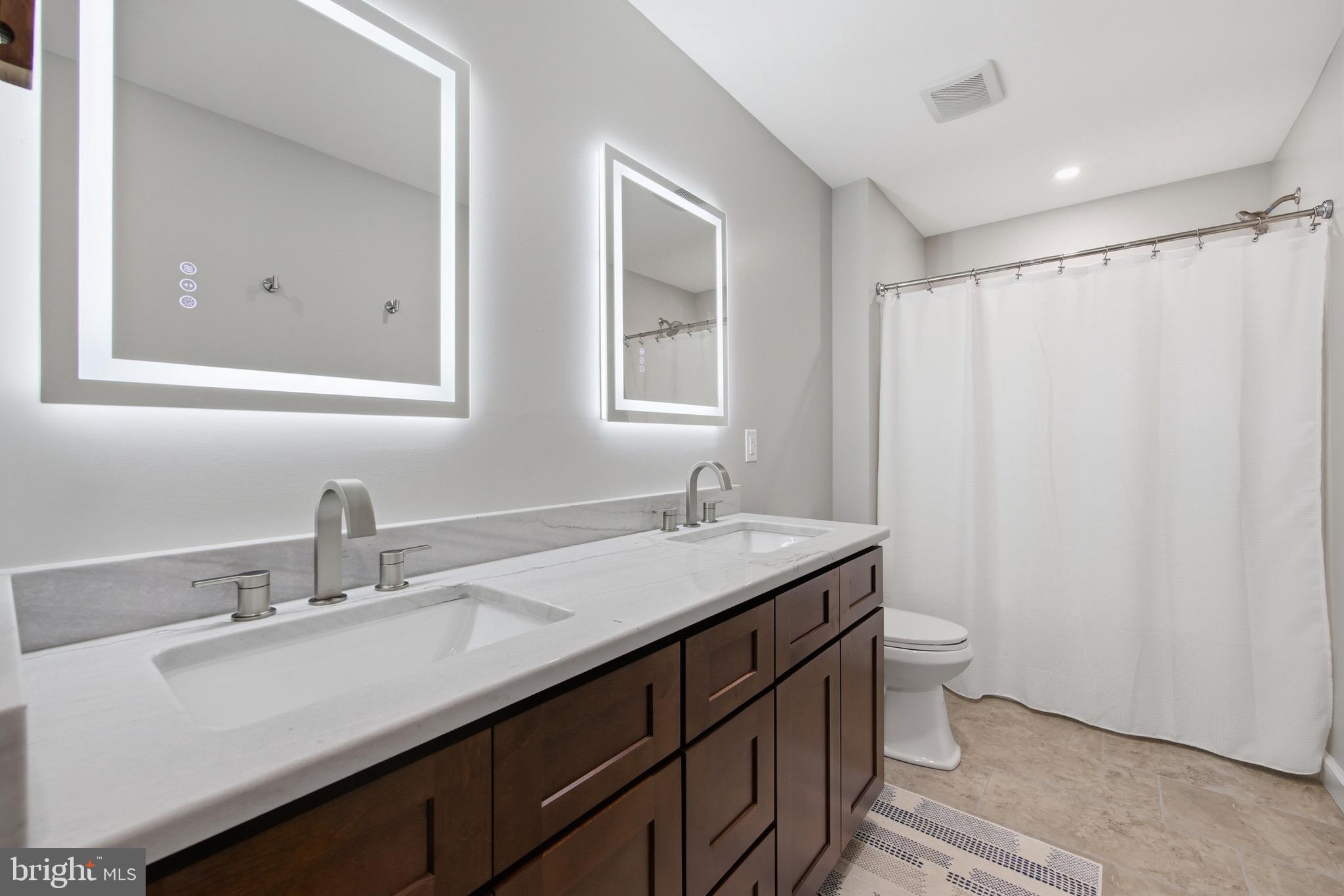 395 Deloris Road Mount Jackson, VA 22842 - Photo 28 of 48 a bathroom with a double vanity sink toilet and a mirror