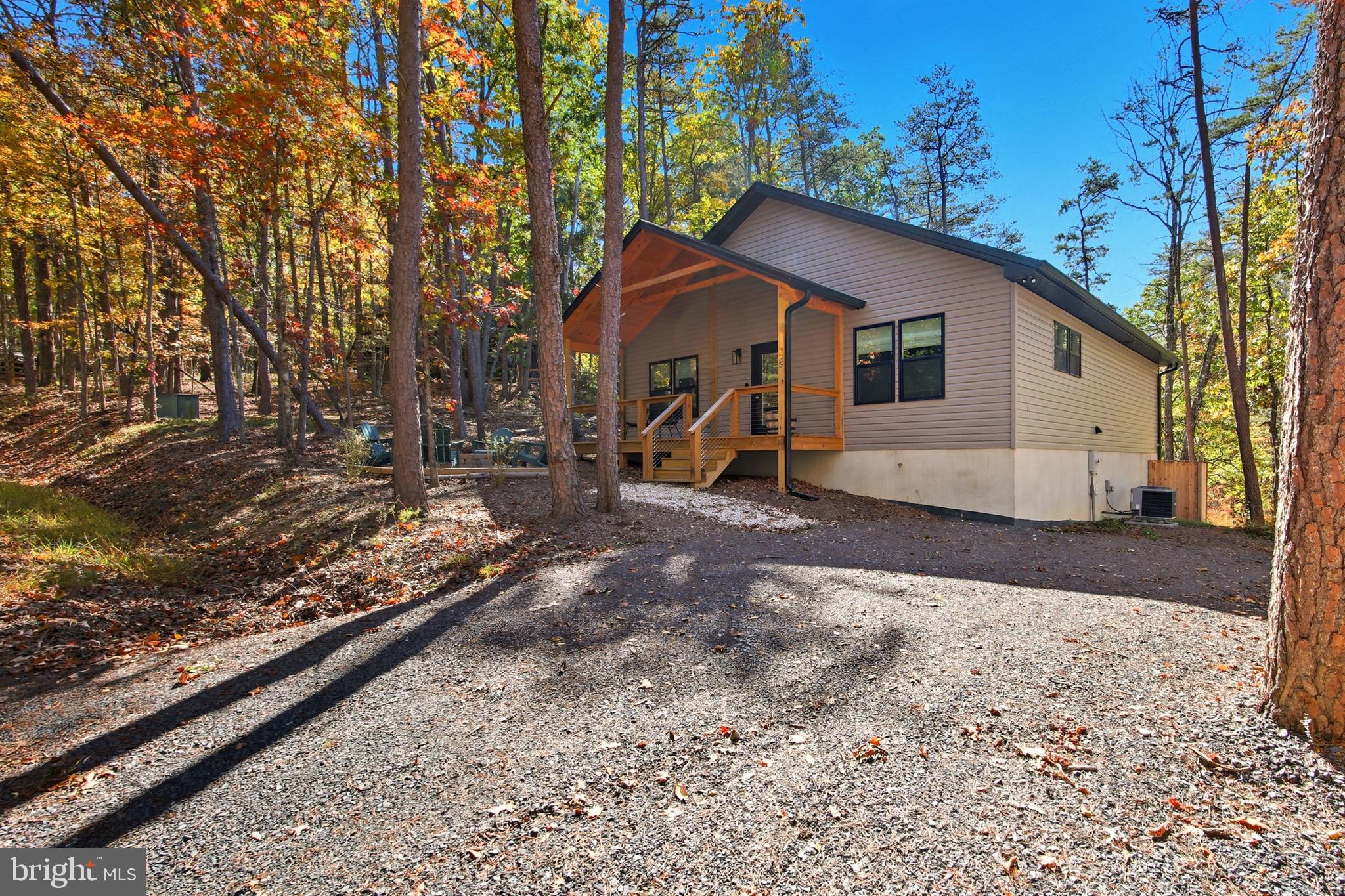395 Deloris Road Mount Jackson, VA 22842 - Photo 7 of 48 a wooden house with a yard and covered with snow