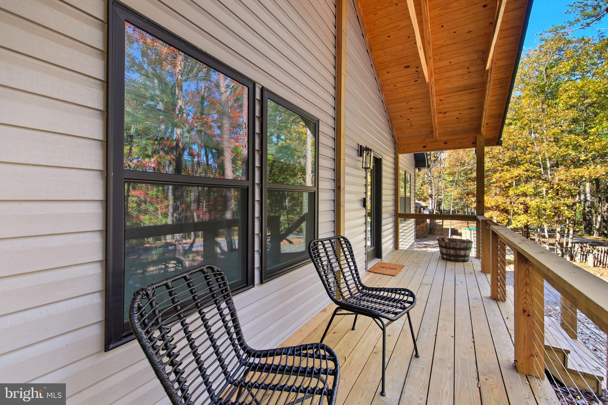 395 Deloris Road Mount Jackson, VA 22842 - Photo 8 of 48 a view of a balcony with chairs and wooden floor