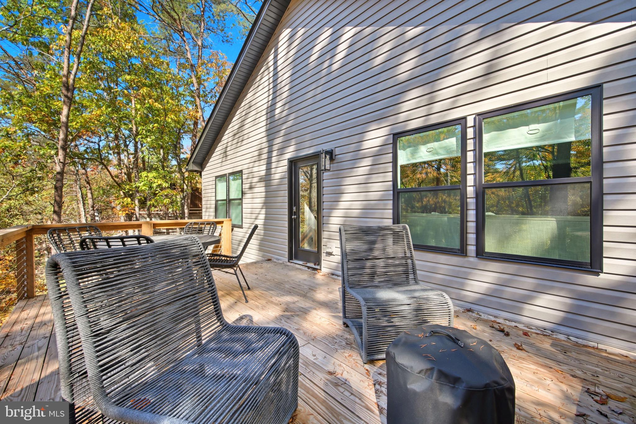 395 Deloris Road Mount Jackson, VA 22842 - Photo 10 of 48 a view of a patio with table and chairs with wooden floor and fence