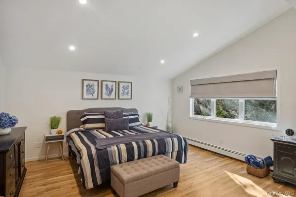 a bedroom with furniture and a window