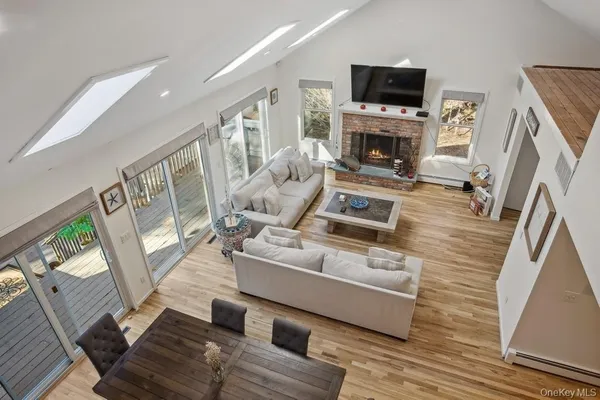 a living room with furniture a flat screen tv and a fireplace