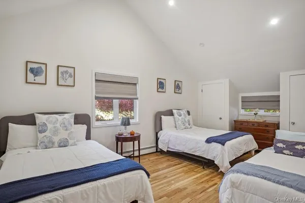 a bedroom with two beds and painting on the wall