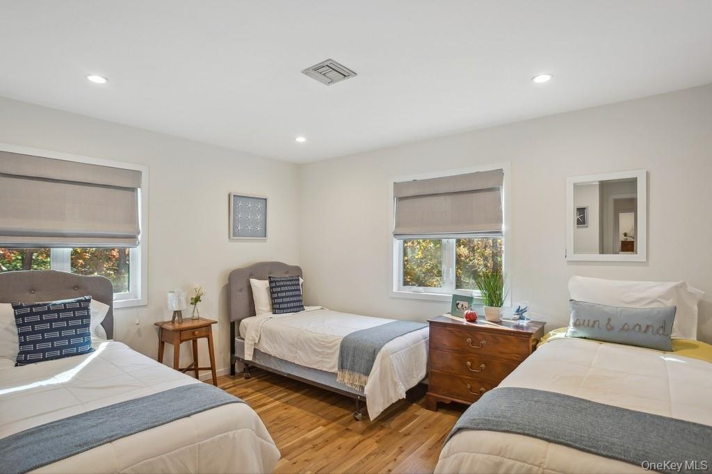 18 Park Circle Quogue, NY 11959 - Photo 19 of 25 a bedroom with a bed and wooden floor