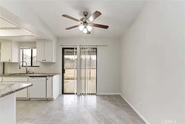 a view of a kitchen with a sink and dishwasher cabinet with wooden floor