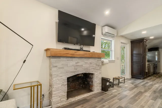 a living room with a fireplace and a flat screen tv