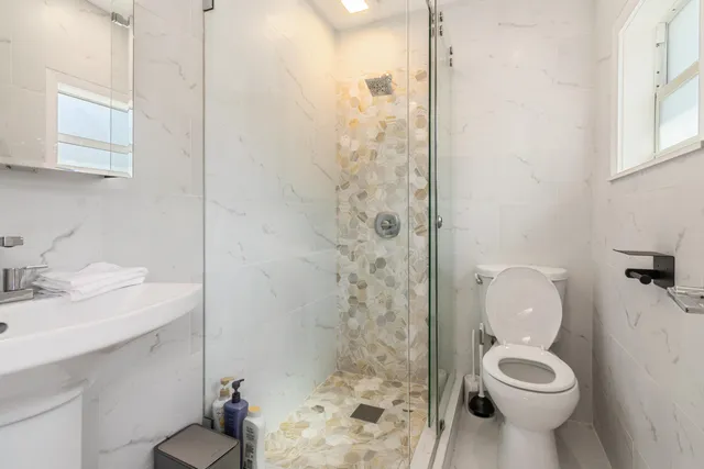a bathroom with a toilet sink and shower