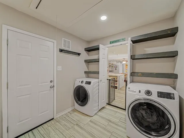 a view of a hallway with washer and dryer