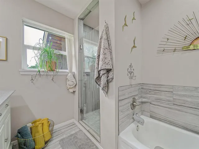 a bathroom with a tub and shower