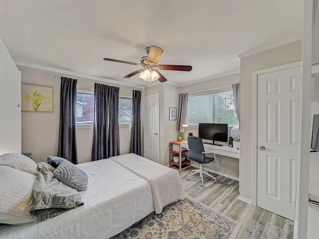 a bedroom with a large bed and a flat screen tv