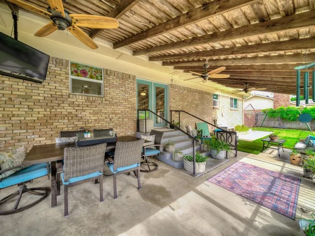 a view of a patio with a table and chairs