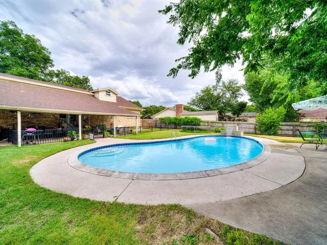 a view of a swimming pool and a yard