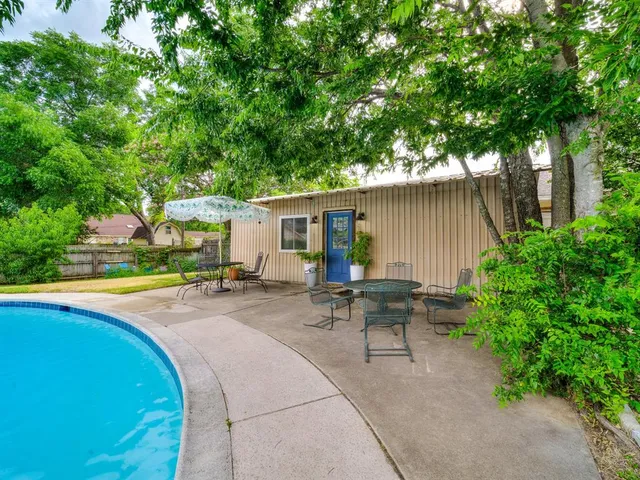 a view of a house with swimming pool and sitting area