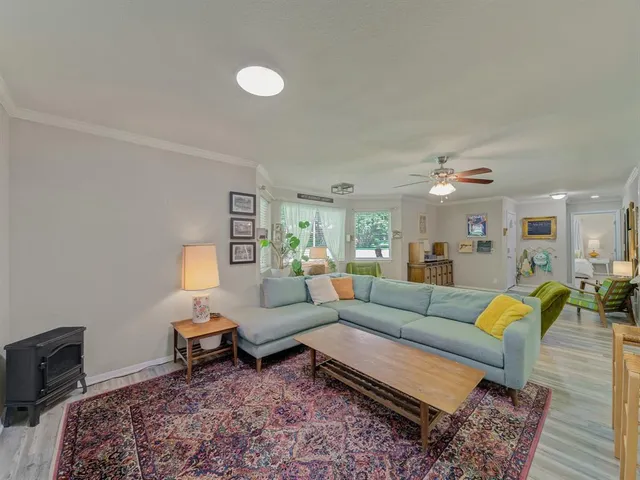 a living room with furniture and wooden floor