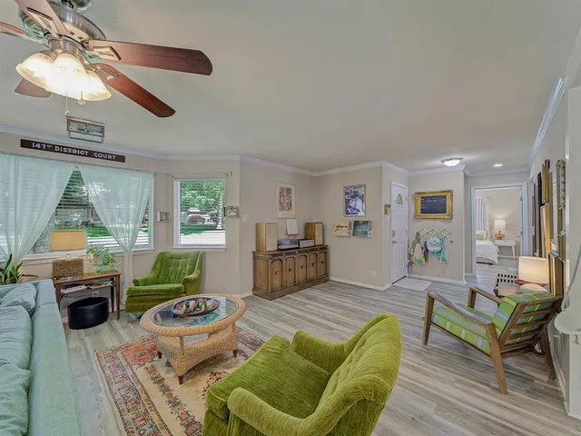 a living room with furniture and a dining table