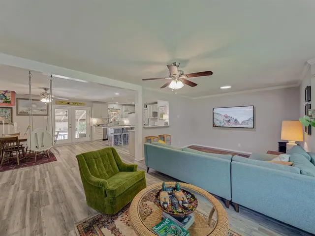 a living room with furniture and wooden floor