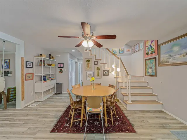 a dining room with furniture and wooden floor