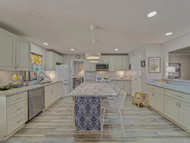 a large kitchen with kitchen island a sink counter space and a center island