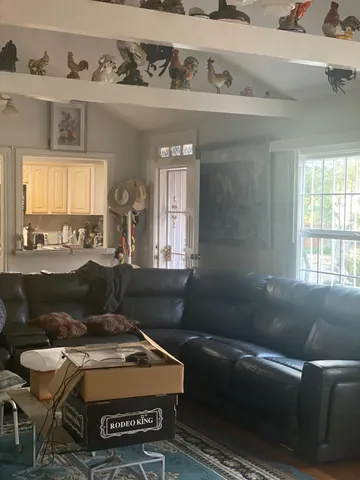 a bedroom with a bed window and mirror