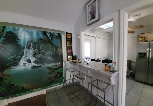 a dining room with furniture and wooden floor