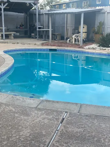a view of a chair and table in backyard