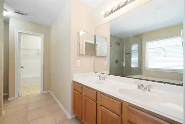 a bathroom with a sink a mirror and a bathtub