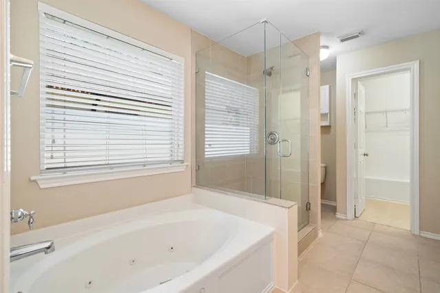 a bathroom with a bathtub and a shower
