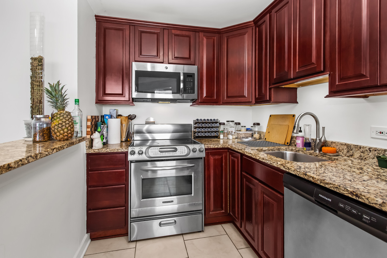 Undisclosed Address Chicago, IL 60613 - Photo 11 of 16 a kitchen with stainless steel appliances granite countertop wooden cabinets and a stove top oven