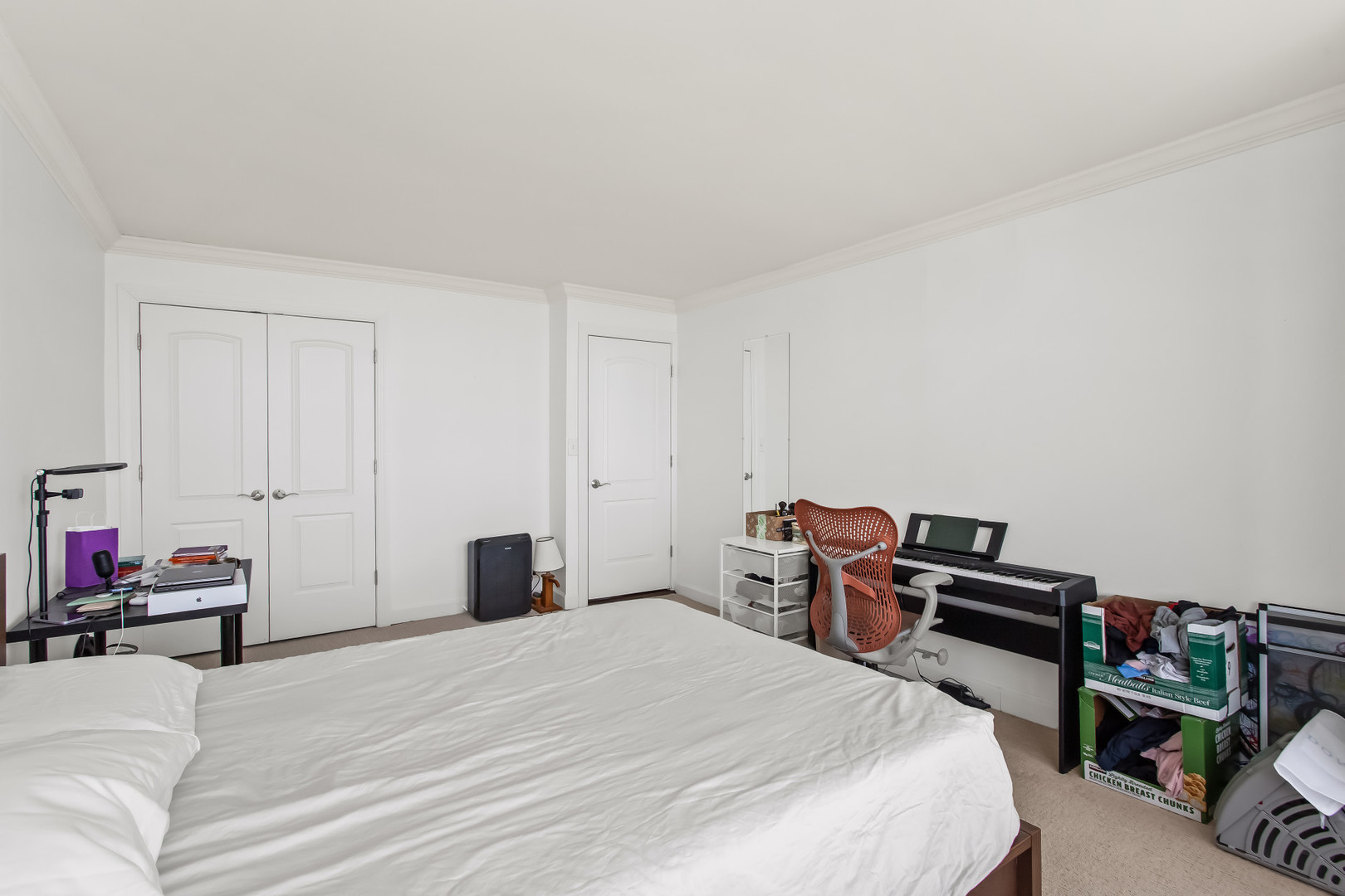 Undisclosed Address Chicago, IL 60613 - Photo 14 of 16 a bedroom with a bed and a chair