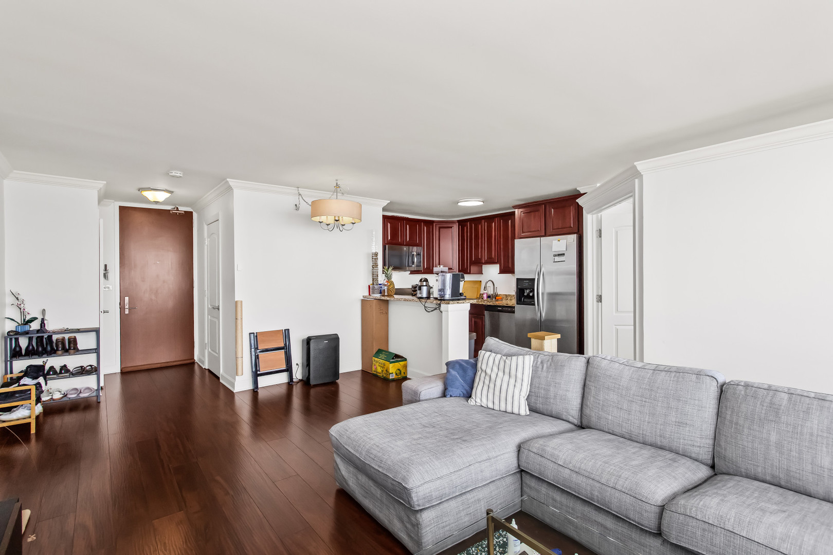 Undisclosed Address Chicago, IL 60613 - Photo 8 of 16 a living room with furniture and a wooden floor