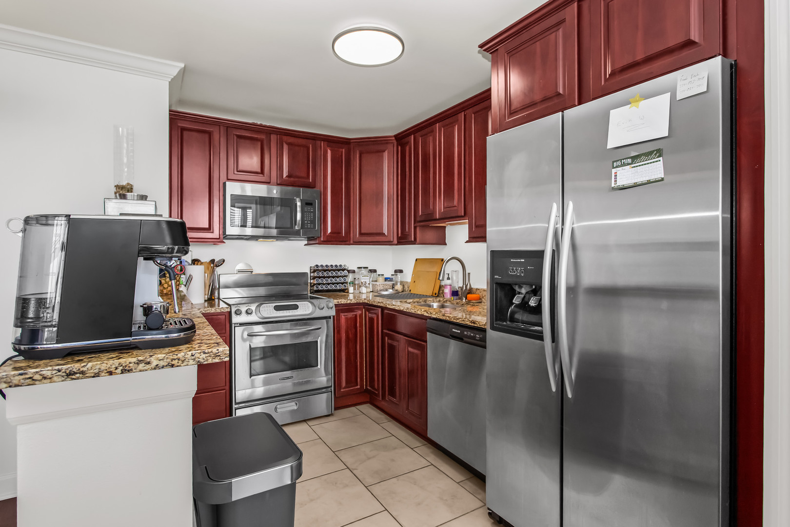Undisclosed Address Chicago, IL 60613 - Photo 10 of 16 a kitchen with stainless steel appliances granite countertop a refrigerator stove and a sink