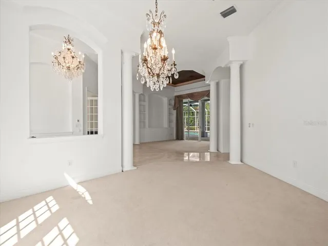 a kitchen that has a kitchen island and a refrigerator in it