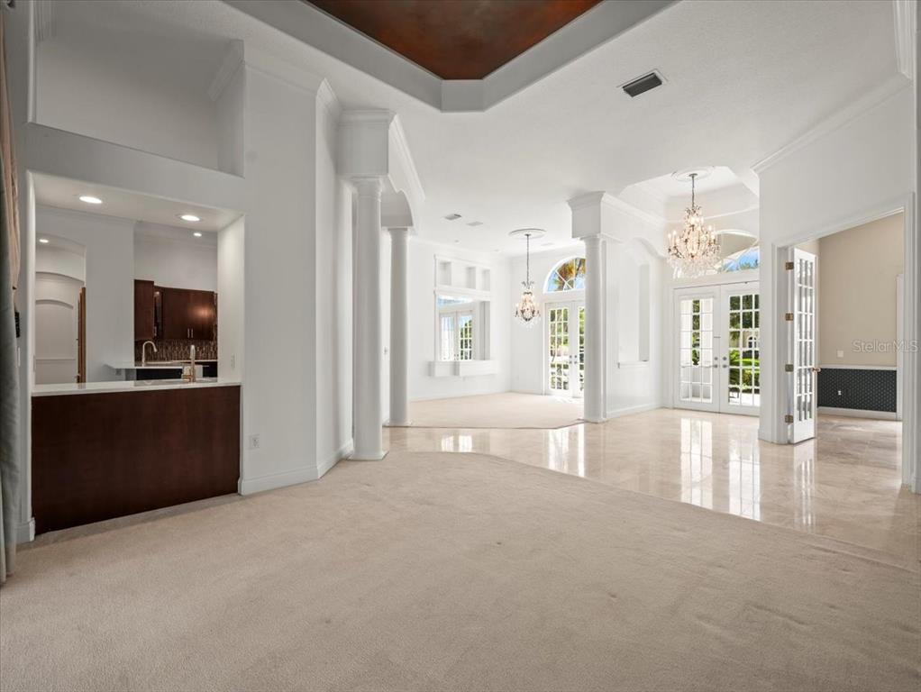 4529 Cheval Boulevard Lutz, FL 33558 - Photo 17 of 83 a view of an empty room and a kitchen with furniture kitchen wooden floor and windows