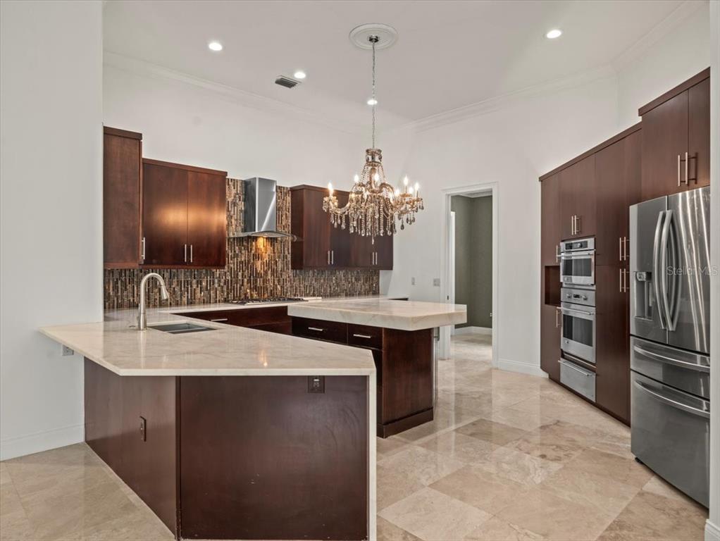 4529 Cheval Boulevard Lutz, FL 33558 - Photo 22 of 83 a kitchen with a sink and refrigerator