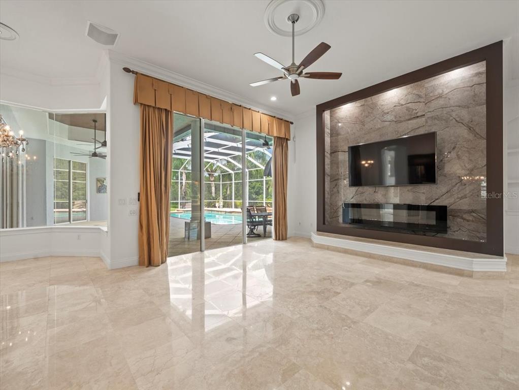 4529 Cheval Boulevard Lutz, FL 33558 - Photo 31 of 83 a view of an empty room with a fireplace and a large window