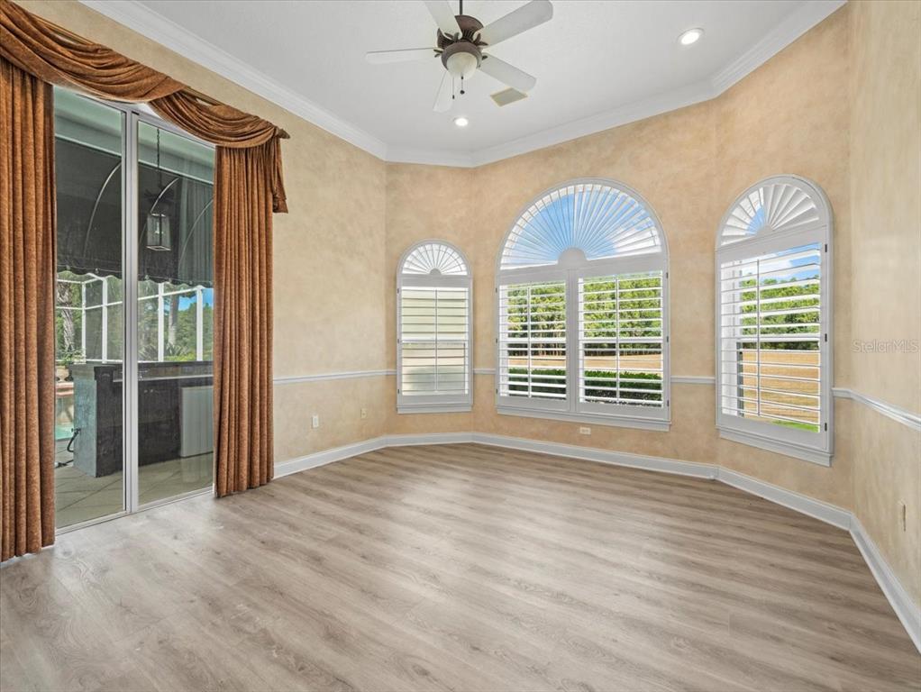 4529 Cheval Boulevard Lutz, FL 33558 - Photo 50 of 83 a view of an empty room with a window and wooden floor