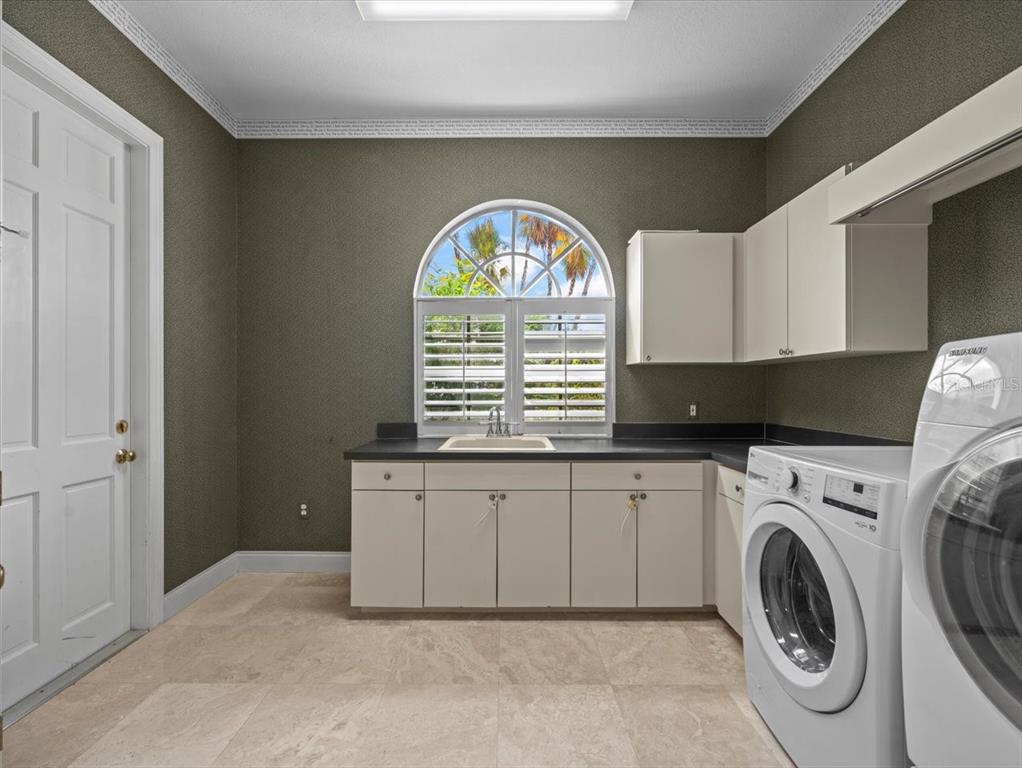 4529 Cheval Boulevard Lutz, FL 33558 - Photo 60 of 83 a view of a kitchen with washing machine and a window
