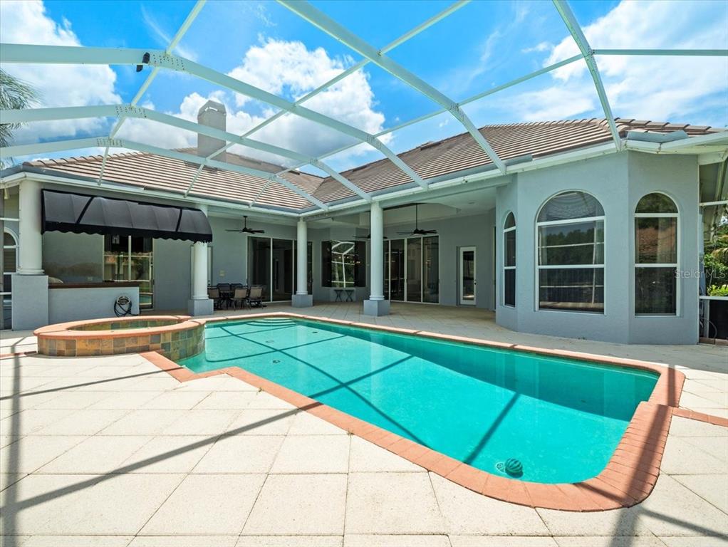 4529 Cheval Boulevard Lutz, FL 33558 - Photo 68 of 83 a view of a patio with a table and chairs under an umbrella