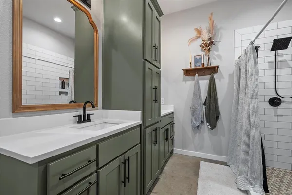 a bathroom with a sink a mirror and shower