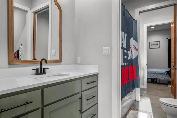a en suite bathroom with a sink and a mirror