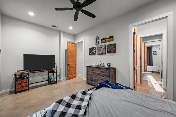 a bedroom with furniture and a flat screen tv