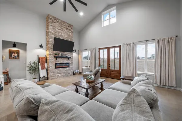 a living room with furniture large window and a flat screen tv