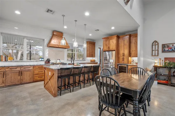 a kitchen with a table and chairs in it