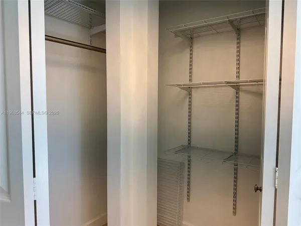 a view of room with a chair and a cabinet